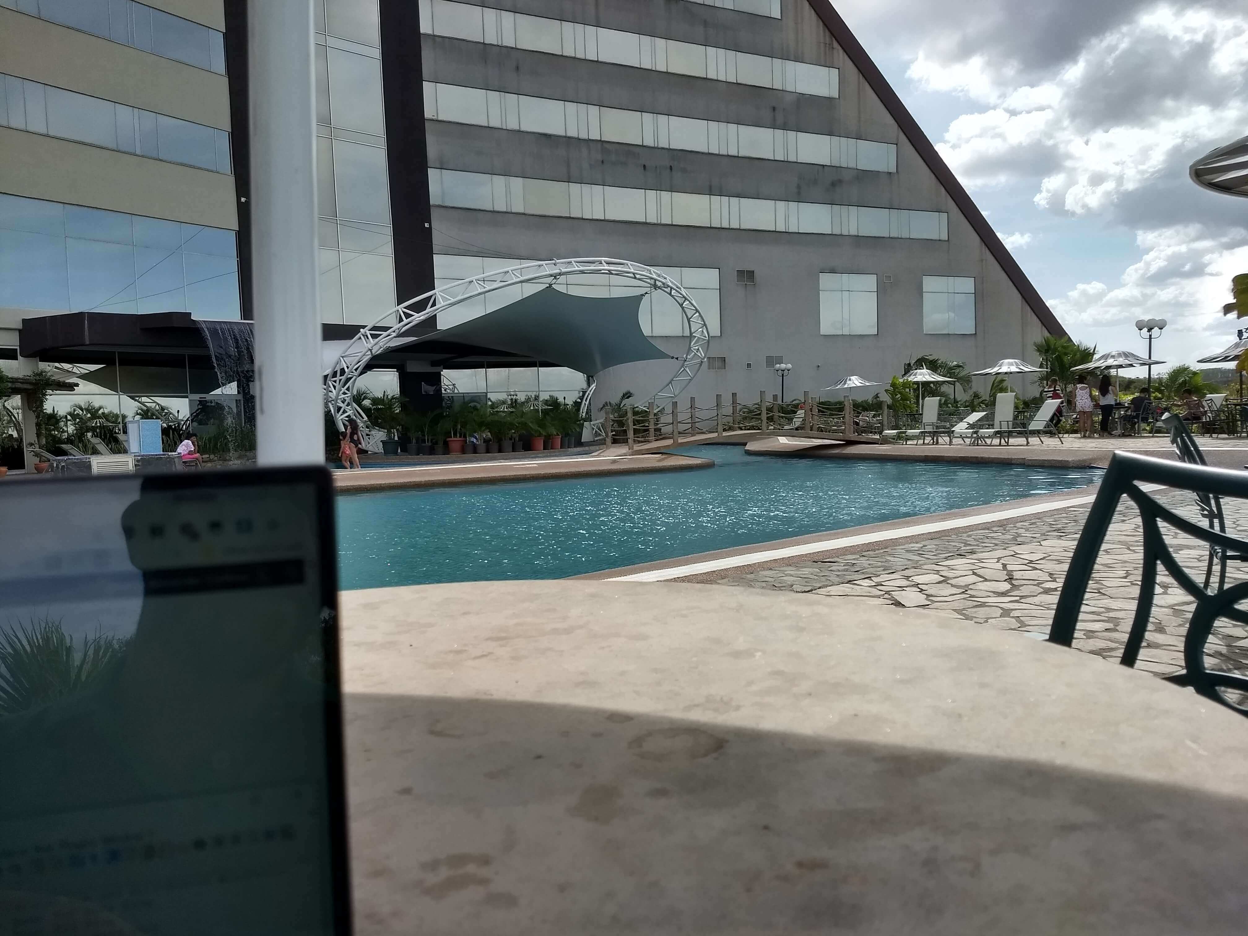 Working from the poolside.