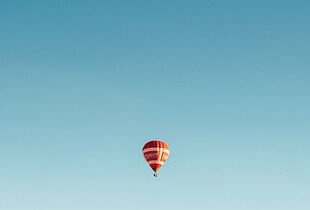 A balloon flying off into the distance