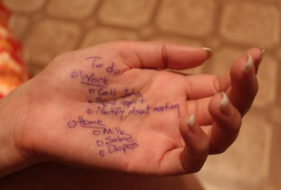 A hand with a to-do list written on the palm.