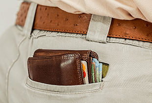A wallet peeking out of a back pocket.