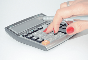 A woman using a calculator.