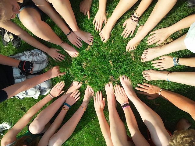 A group of people joining hands.