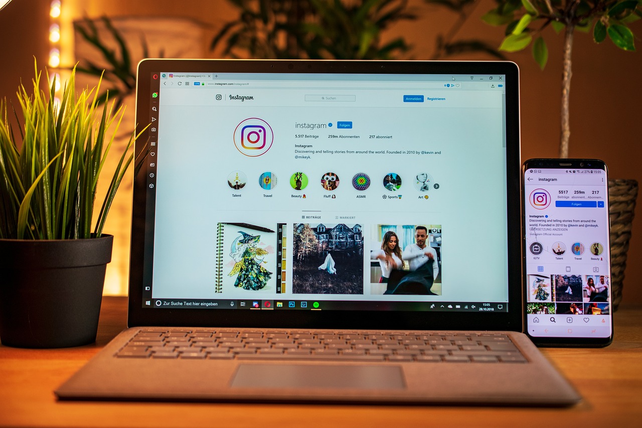A laptop and a phone displaying an Instagram account.